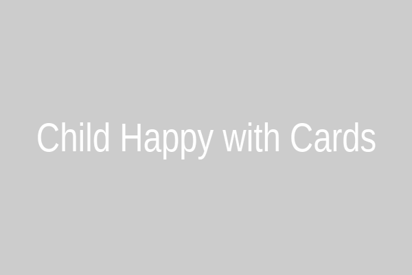 A child happily presenting handmade cards