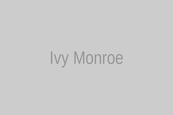 Ivy Monroe in oversized cardigan and round glasses