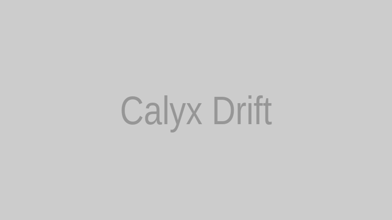 Calyx Drift posing in a simple white and silver futuristic outfit under even lighting