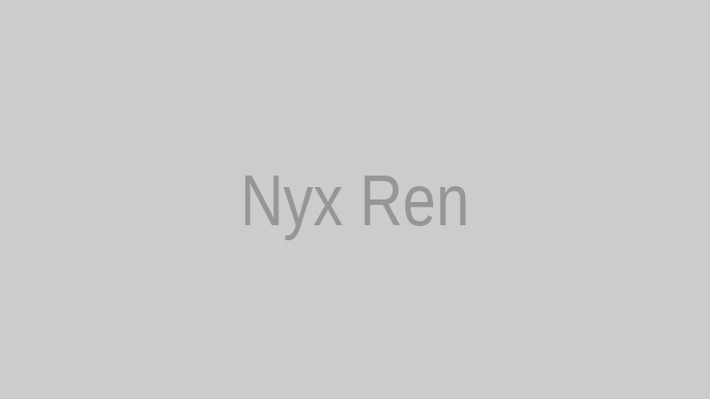 Nyx Ren standing in a chrome hallway with subtle blue accent lighting