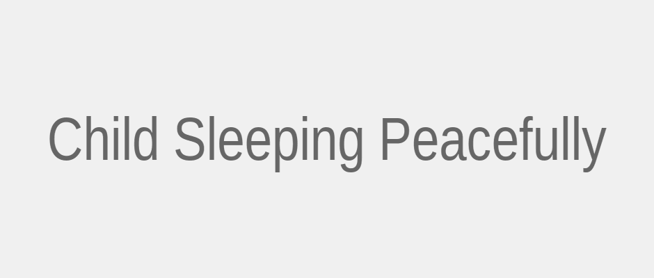 Child sleeping peacefully in dark room